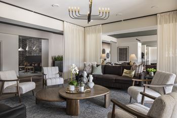 A modern living room with a large coffee table and comfortable seating.